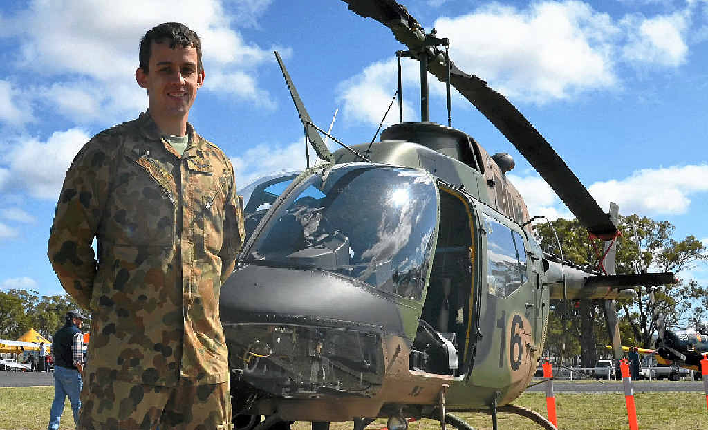 WINGING IT: Lt Andrew Caldwell with a Kiowa military helicopter based in Oakey at the Wings over Warwick fly-in on Saturday. WINGING IT: Lt Andrew Caldwell with a Kiowa military helicopter based in Oakey at the Wings over Warwick fly-in on Saturday.